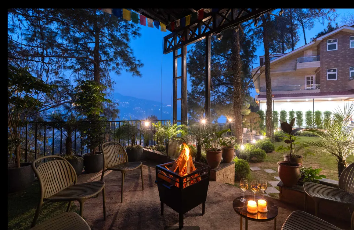 Evening bonfire on the terrace with the mountains beyond