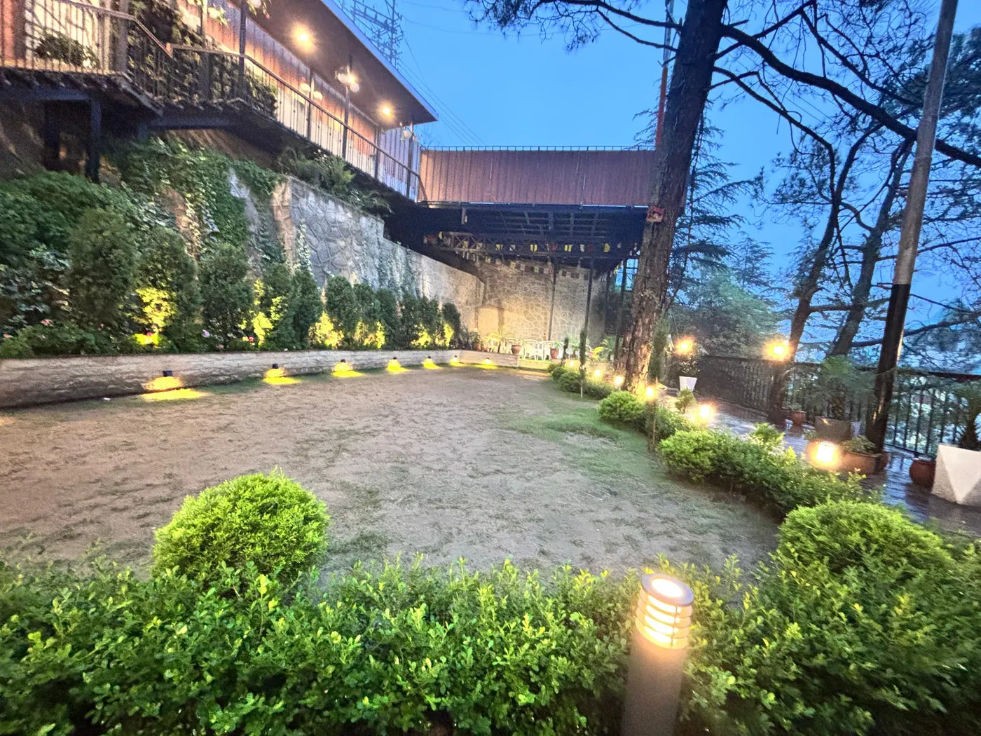 The lawn at dusk lit by soft uplights